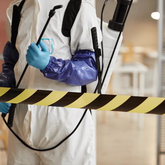 worker standing in front of police tape during Crime Scene Cleanup in Garland, Texas