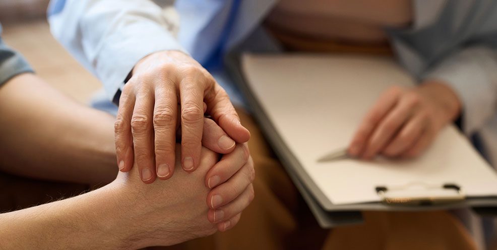 a person's hand on top of another person's after an unattended death in Cleburne, TX